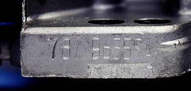 Cater 9635SA stamped number on the front right foot of carburetor enhanced for legibility